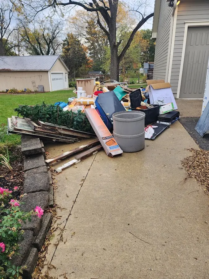 Dumpster being loaded with debris for Roofing Dumpster Rental in Ukiah